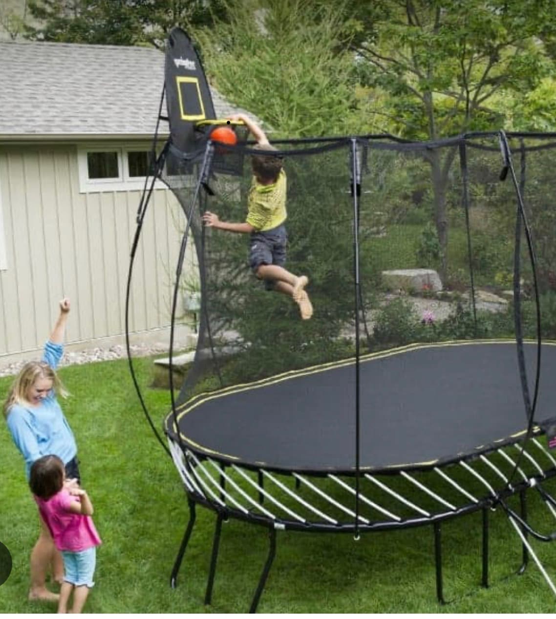 Family enjoying a trampoline in their backyard